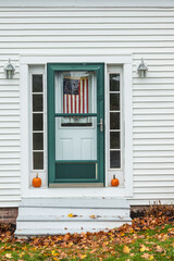 USA, Maine, Wiscasset. House detail with US flag during autumn.