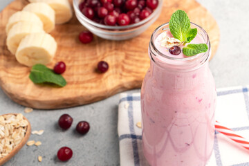 Homemade yogurt smoothie with banana, cranberry and oatmeal