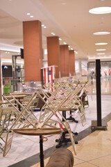 Chairs stacked on tables in a Spanish mall. Bar closed by coronavirus.