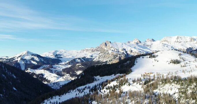 Val Gardena in Winter, Aerial Landscape. Mountains and Forest covered in Snow. Ski resort and popular tourist destination in the Alps for vacation and sport activities.