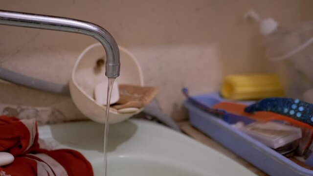 Water Run into Sink from Old Water Tap in Dirty Bathroom. Water Leak. 4K