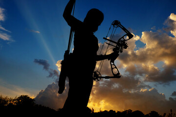 Silhouette of people playing archery