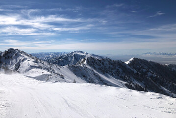 Fototapeta na wymiar Ski Slope with Snowy Mountains in Distance