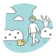 犬と公園を散歩する男性