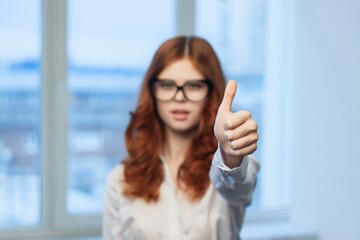 female manager in white shirt gesturing with hands in the office professional