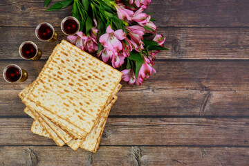 Fototapeta na wymiar Traditional four cups full of wine with matzoh. Jewish holidays Passover.