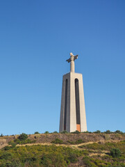 National Sanctuary of Christ the King or Santu&aacute;rio de Cristo Rei in blue sky background. Catholic statue Sacred Heart of Jesus Christ inspired by Rio's Christ the Redeemer. Lisbon, Portugal.
