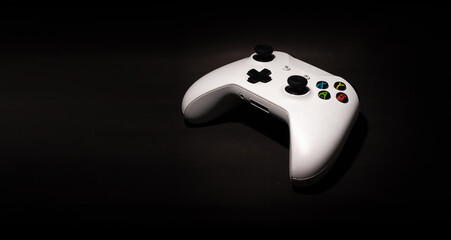 Video game controller on black background and space for text. © XM4THX