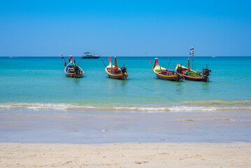 Obraz premium Long tail boats on Kamala beach on Phuket island in Thailand.
