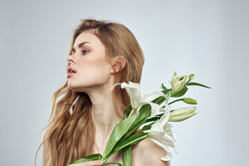 Naklejka premium girl with flowers cropped view portrait close-up spring bare shoulders clear skin Make Up