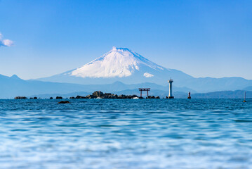 Seascape of Mt.Fuji with torii and lighthouse in the noon at Manase Coast. Yokosuka City, Kanagawa Prefecture, Japan.
