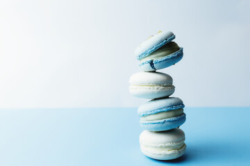 White and blue macaroons on the table, macaroons on white blue background