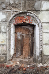 the window of an old ruined building, clogged with boards