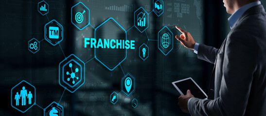Businessman hand touching inscription Franchise marketing system