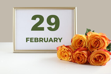 Day of the month calendra photo frame and yellow rose on the table