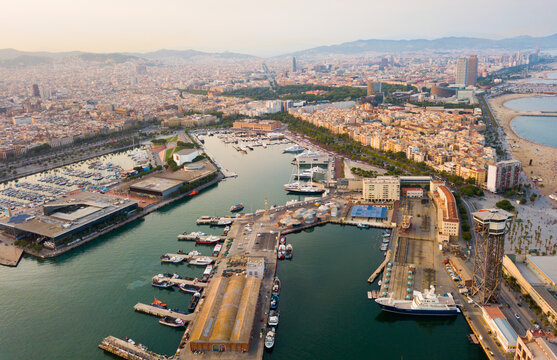 Image of aerial view of old port in Barcelona city with of sailboats and yachts
