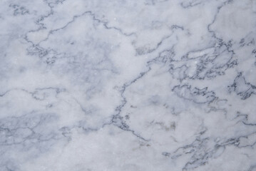 the texture of a gray marble slab made of natural stone. background of the marble surface with a blue tint