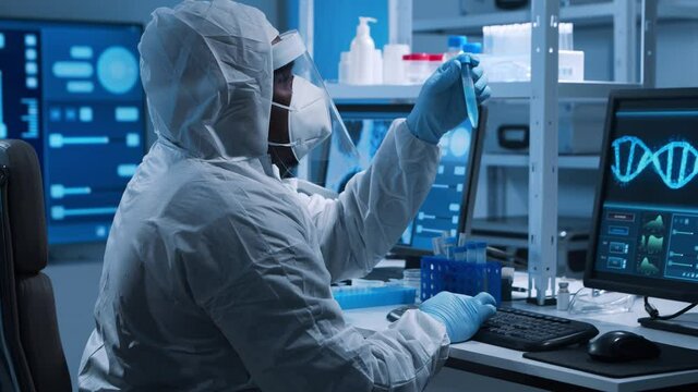 African-American doctor is doing a science experiments and developing vaccine in a modern laboratory. Genetic engineers workplace. The concept of science and medicine.
