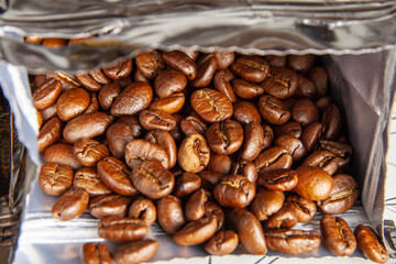 Coffee beans are in an open package. Close-up