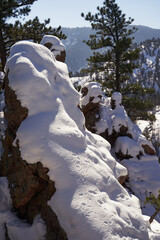 Snow covered bulbouse rocks.