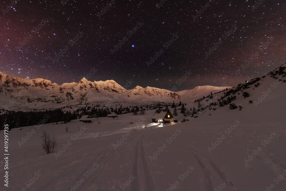 Wall mural night winter landscapes in the high tatras, with mountain houses on a background of snow-capped moun