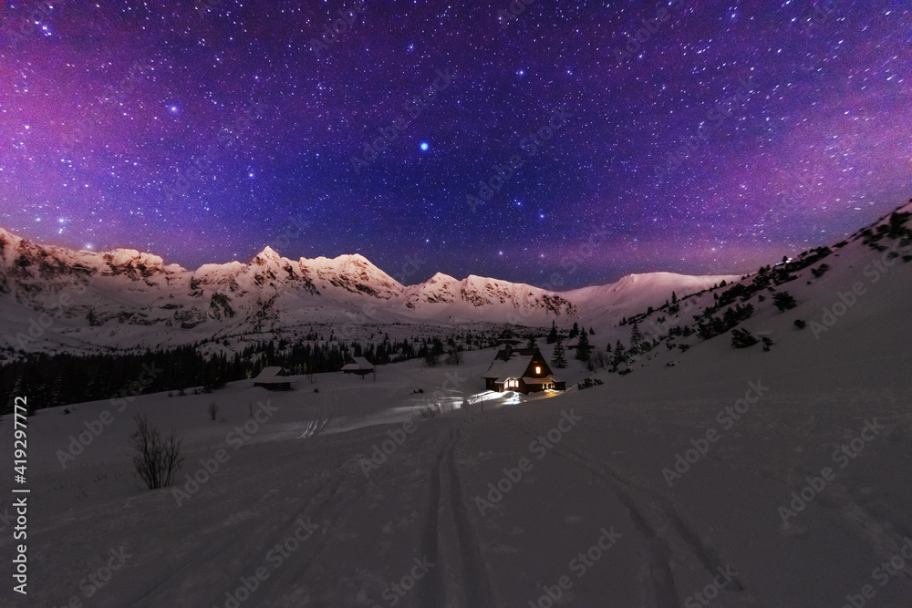 Wall mural night winter landscapes in the high tatras, with mountain houses on a background of snow-capped moun
