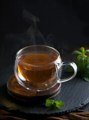 Tea concept, teapot with tea surrounded on wood background, tea ceremony, green tea in a transparent cup