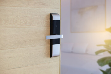 Digital Door handle or Electronics knob  for access to room security, Door wooden half opening through interior living room background, selective focus