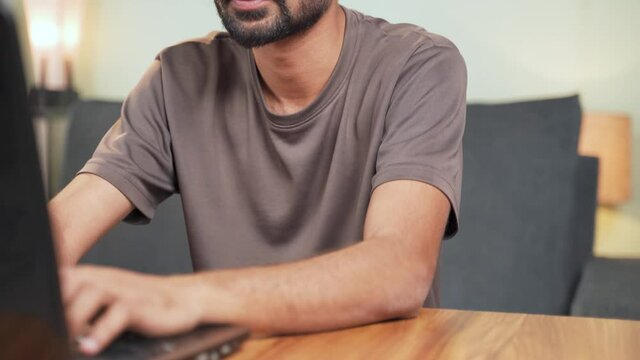 Selective rack focus between mug and man, giving empty coffee to man while busy working on laptop to make him fool - Concept of making prank during April fools day