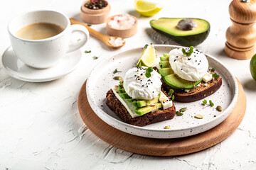 Sandwich with avocado and Poached Egg. Wholemeal Bread Toast sliced avocado and egg with cup of coffee for healthy breakfast or snack