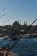 Fototapeta na wymiar Great Mosque in Istanbul. View from a high bridge, where local fishermen fish with fishing rods.