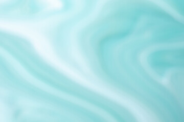 Abstract blurred light turquoise and white background with wavy lines pattern.