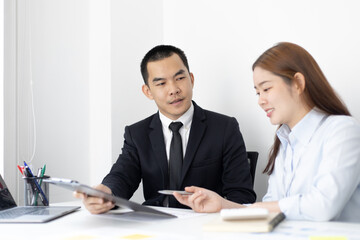 Fototapeta premium Brainstorm team, Marketers and financial accountants are discussing and analyzing charts to plan strategies to meet customer needs, Computer technology for business concept.