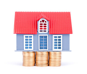 A model of a house held up by coins