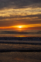 Fototapeta na wymiar A beautiful sunrise from the shore of the beach