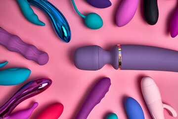 Erotic pleasure toys for female on pink background. Sex gadgets and masturbation devices. Silicone...