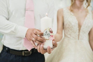 the bride and groom hold hands