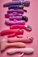 Erotic Sex Toys In Row Isolated On Pink Background. Flat Lay. Sex Shop Concept. Creative Photo Of...