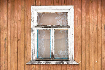 Grungy window in white frame, old wooden house wall texture