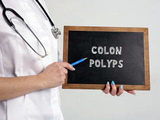 Healthcare concept meaning COLON POLYPS with phrase on the chalkboard.