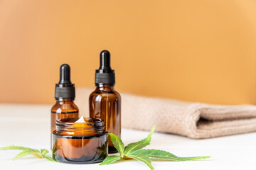 Cannabis face cream or serum or oil dropper concept. Natural cosmetic. CBD oil, THC tincture and...
