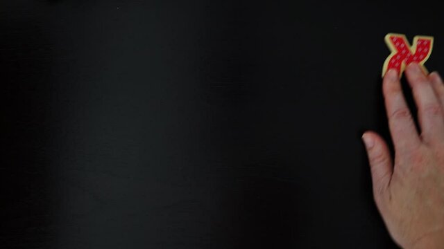 POV (Point of view) of Israeli Jewish person organizing the  Hebrew alphabet letters on a black wooden table.