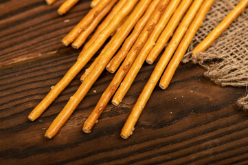 Salty bread strips scattered on a background of coarse homespun fabric.