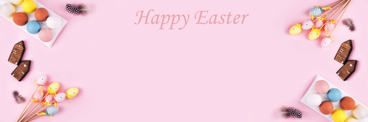 Banner made from colorful Easter eggs over pink background.