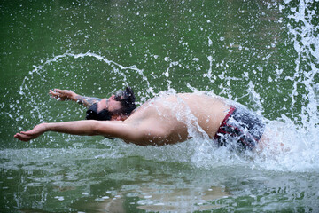 Summer man swimming in water. Summertime vacation weekend.
