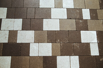 Background of stones on the sidewalk. The shape of square bricks on the road.