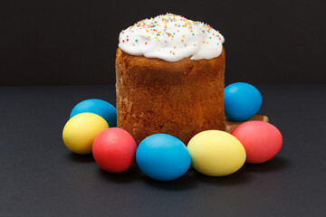 Easter cake and colored Easter eggs in black background.
