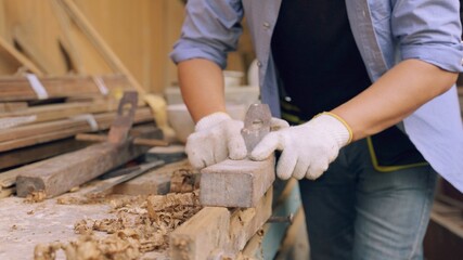 Professional asian carpenter working on wood craft in workshop to produce wooden furniture during...