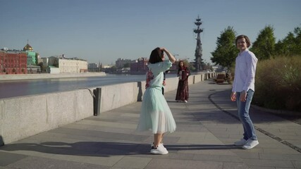 Dancers are dancing a Spanish dance on the river embankment. Street musicians and dancers.