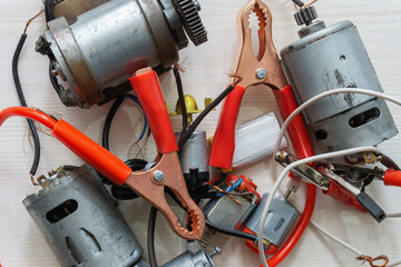Abstract background of electrical appliances, wires, various debris, connecting elements. The...